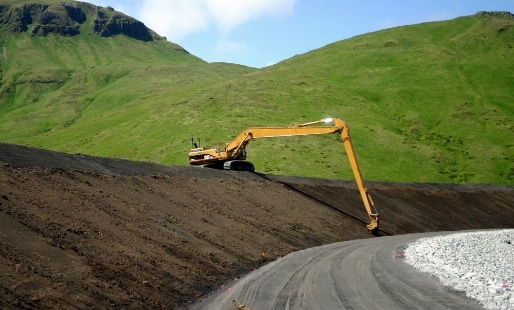 Construction equipment building road in Alaska using GPS Alaska technology
