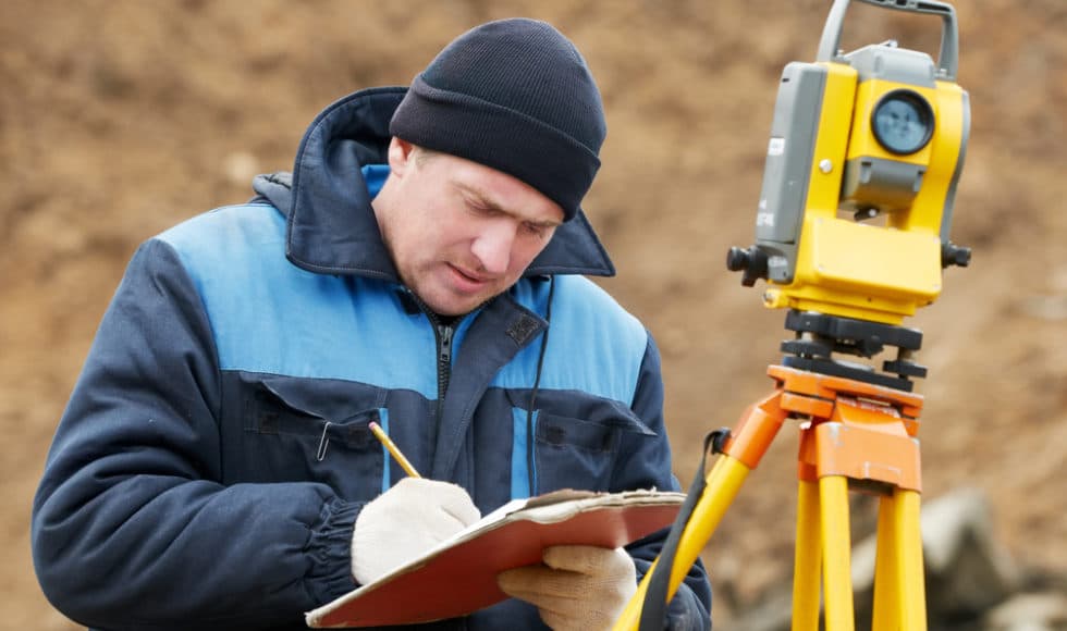 Surveyor calculating construction data