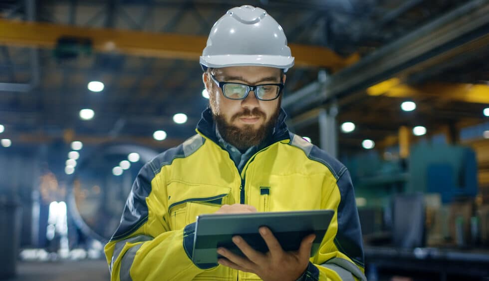 Construction worker looking at digital building layout