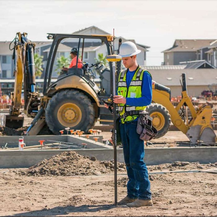 Construction worker setting up HiPer VR GNSS Receiver 