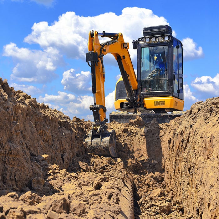 Excavator digs trench using the iDig Grade Control System