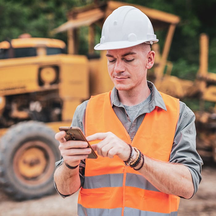 Road worker checks in with office on phone using MAGNET Enterprise