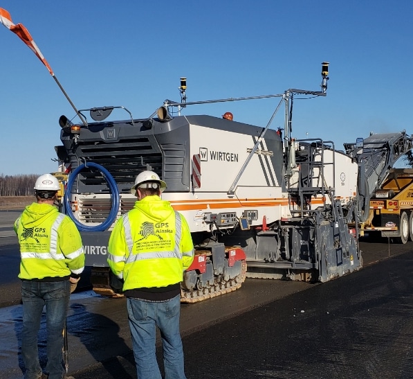 GPS Alaska workers repair paving equipment