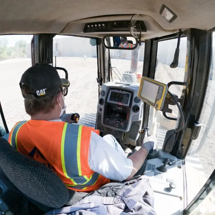 Operator in bulldozer cabin using the MC-Max Dozer 