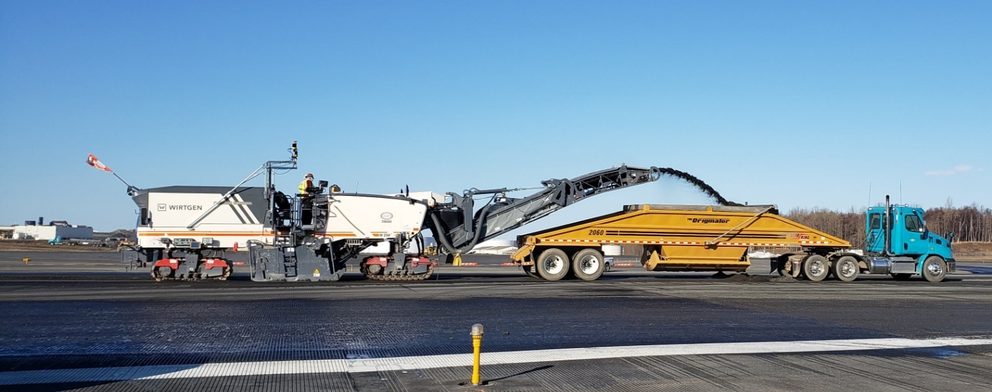 Paver and miller machine control system at work on Alaskan road