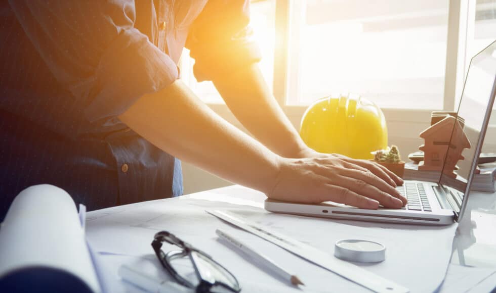 Construction worker using remote construction site management tools