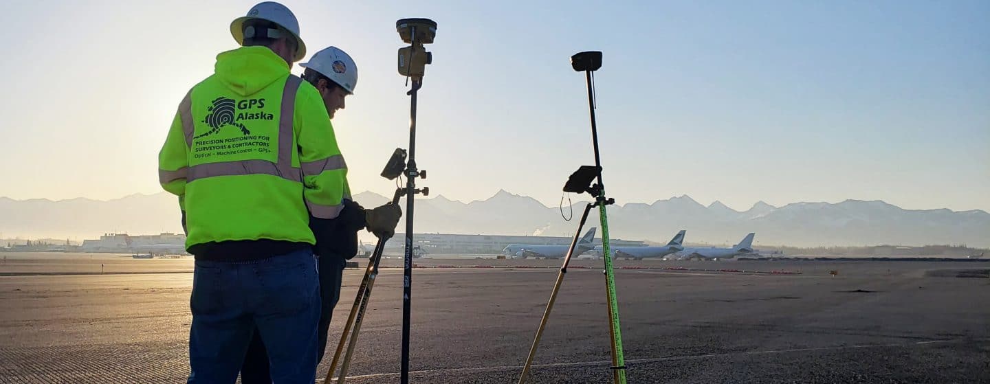 GPS Alaska workers set up surveying equipment