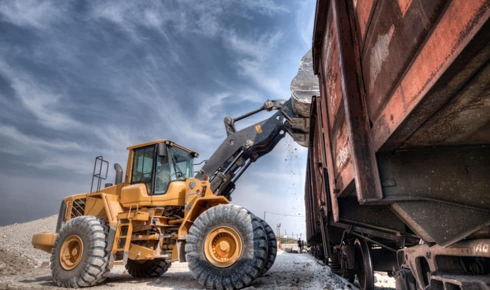 Wheel loader unloading into a railcar and using the scale system